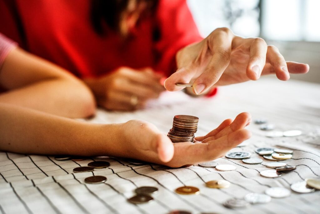 Hand folds coins onto palm